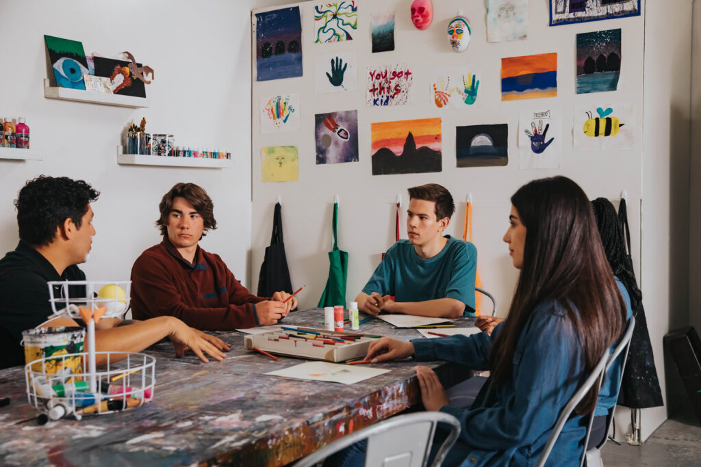 Teens in an art room at evolve treatment for adolescent mental health