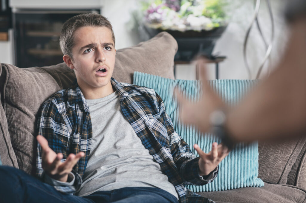 Teenage boy arguing with parent