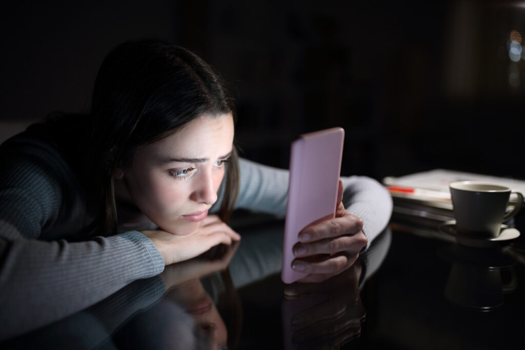 teen girl surfing social media on phone