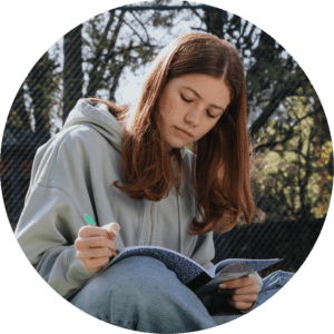 Girl sitting outside journaling