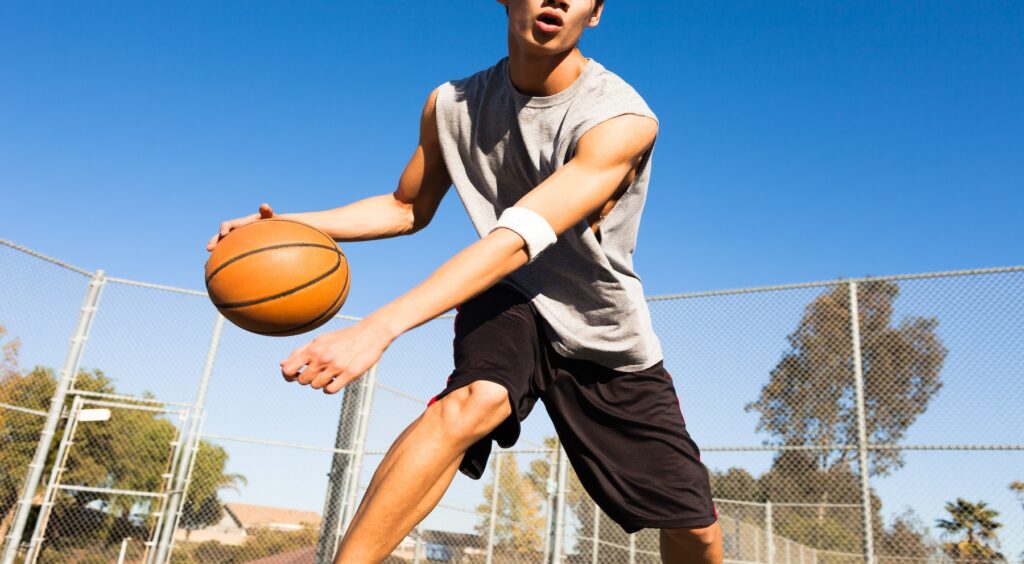 Teen playing basketball