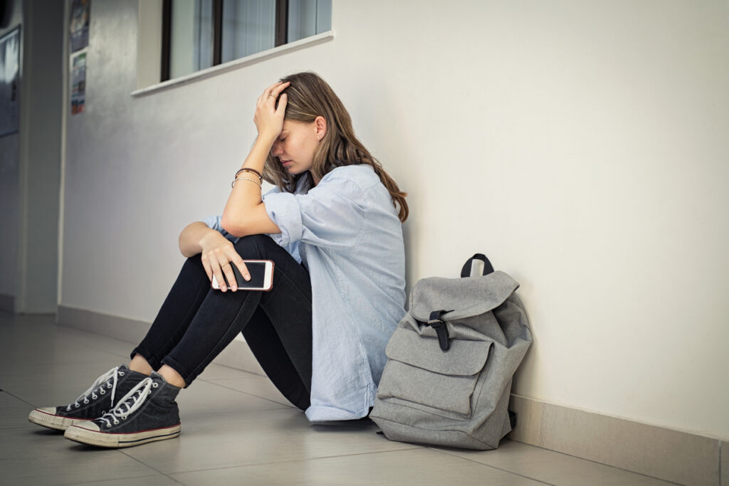 depressed teen girl sitting floor