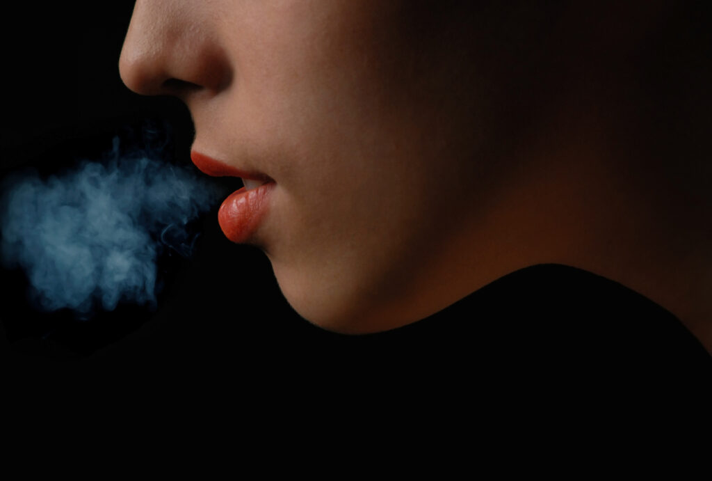 marijuana smoke coming from teen girl mouth