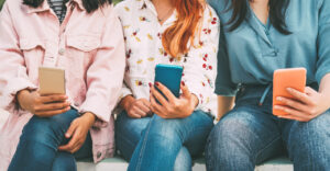 teen girls watching tiktok on phones
